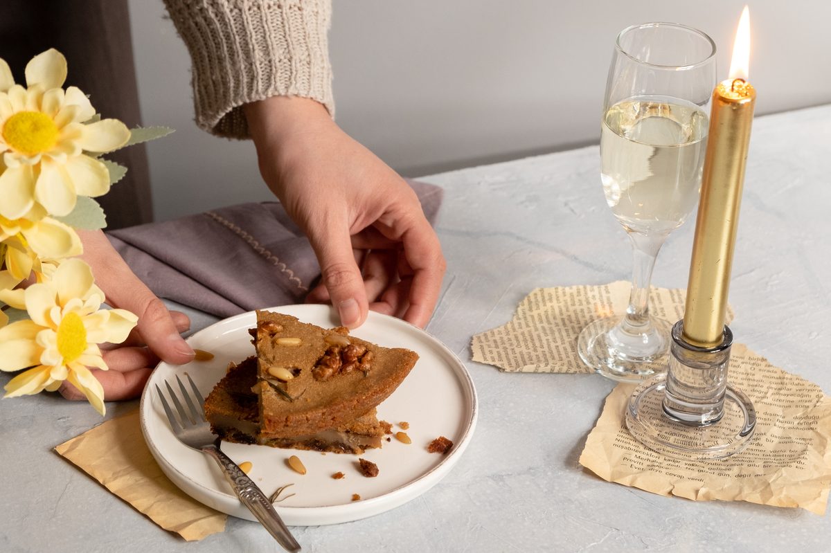 Walnut cake with candle and champagne